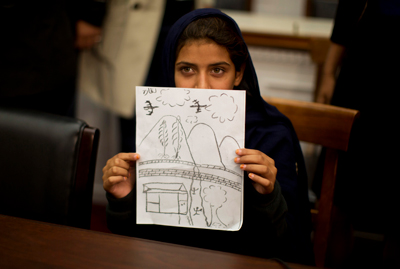 Nabila Rehman, 9, holds up her drawing of the U.S. drone strike on her Pakistan village, which killed her grandmother. © 2016 by REUTERS/Jason Reed.