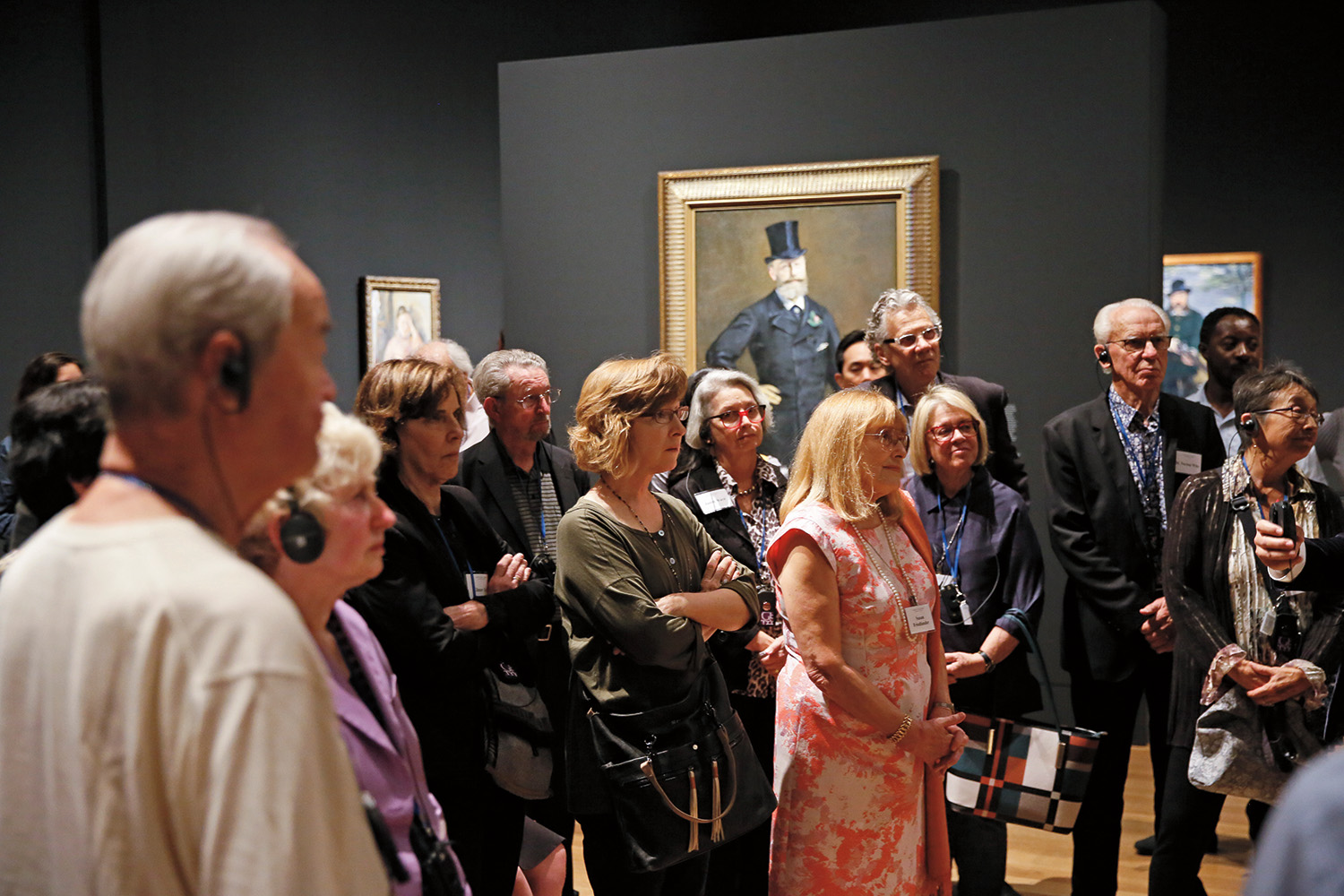 A group of visitors at the Getty Center in Los Angeles, California listen to a presentation at the art museum. 