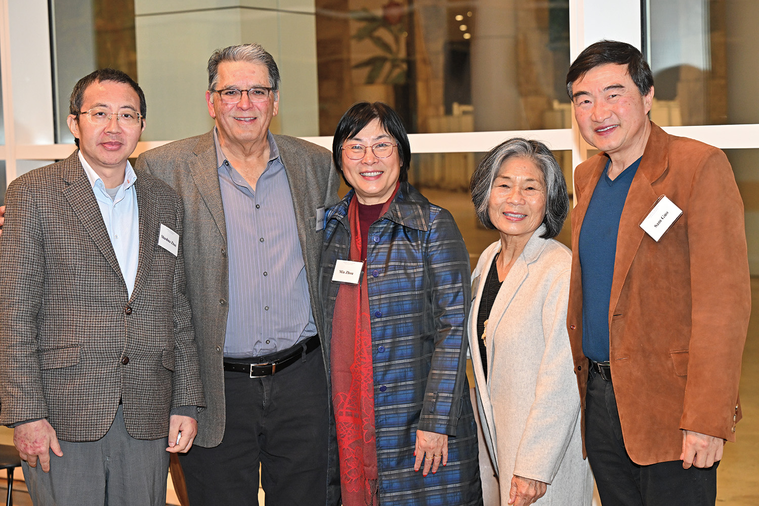 Several individuals smiling for a group picture.