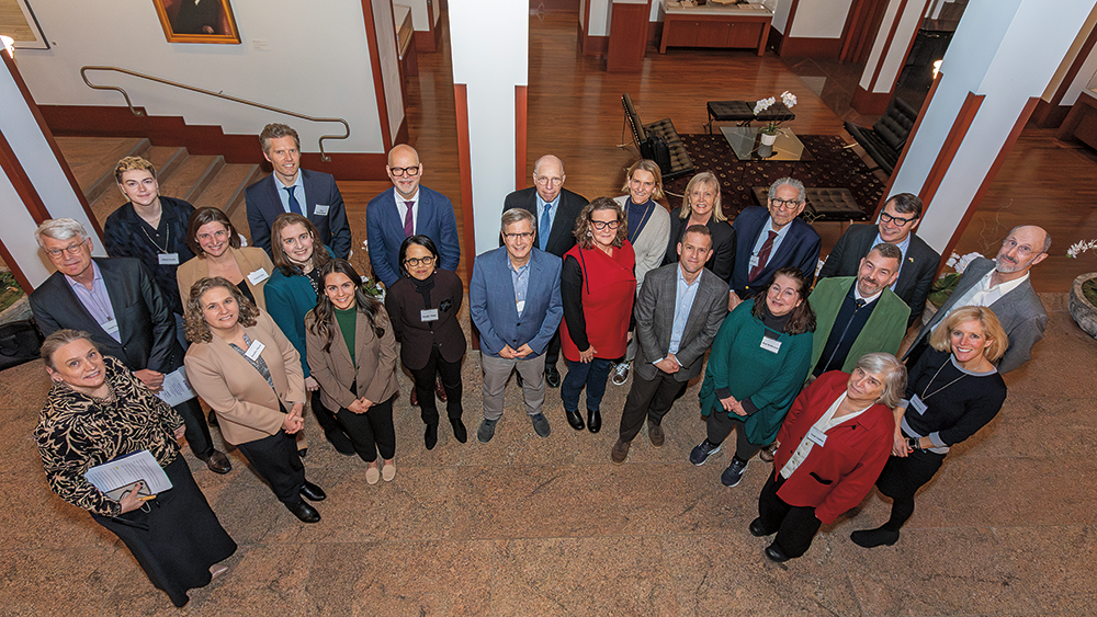 A group of people posing for a picture in a hallway.