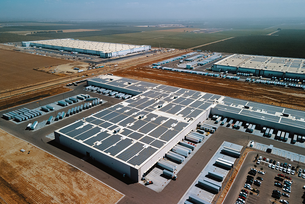 An aerial view of the outside of a warehouse complex on a sunny day. 