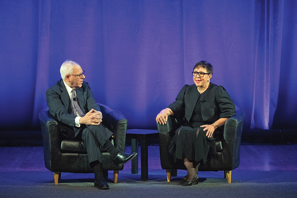 David Rubenstein sits onstage beside Sheila Johnson during their interview at the 2023 Induction ceremony.