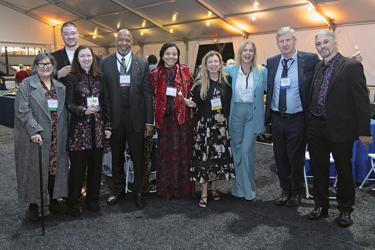 Nine attendees gather at the receptions after the 2023 Induction ceremony.