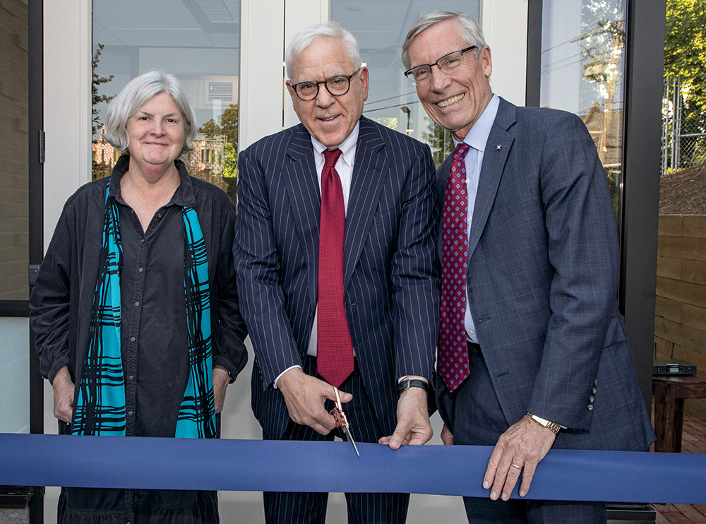 A photo of Nancy C. Andrews, David M. Rubenstein, and David W. Oxtoby in front of the newly opened David M. Rubenstein wing at the American Academy of Arts and Sciences. 