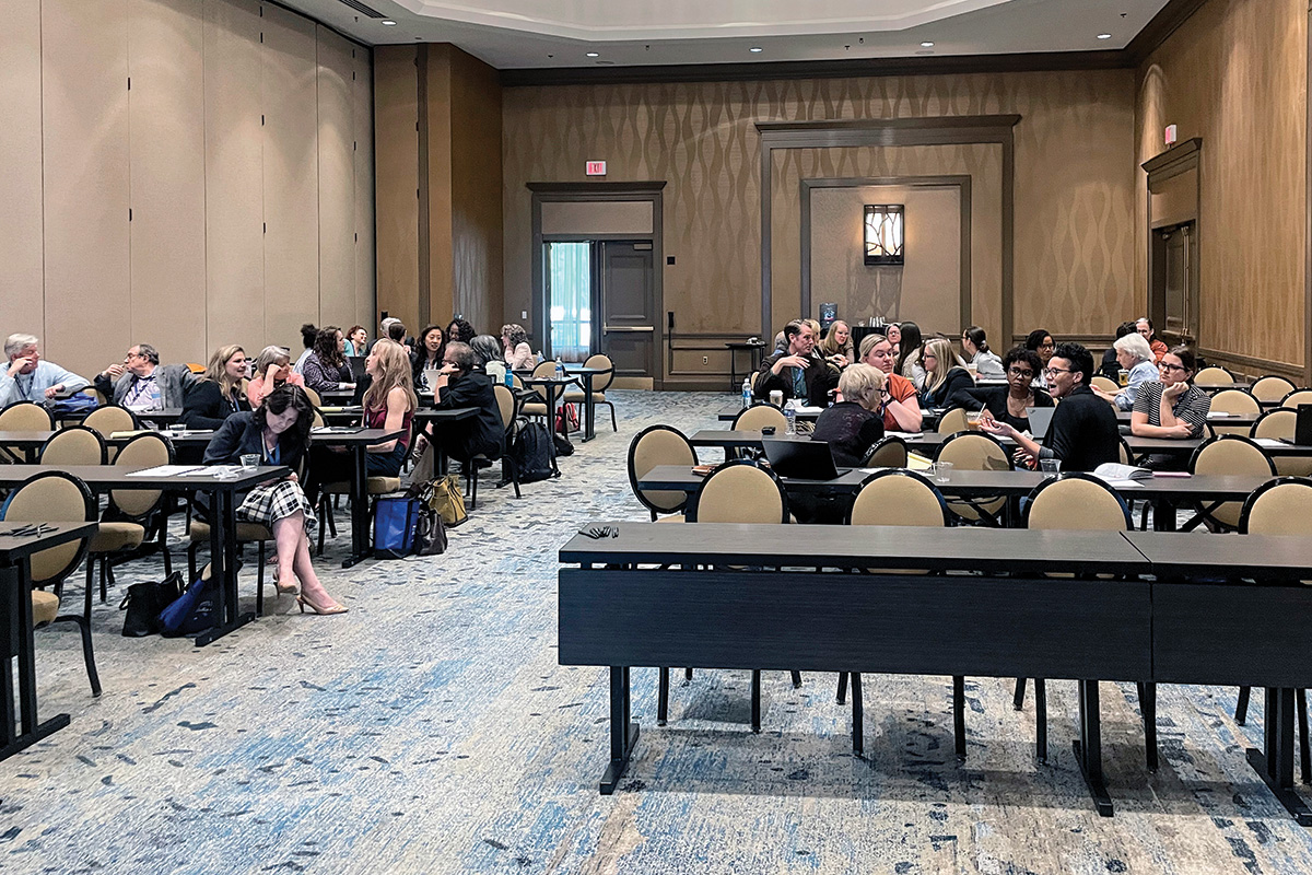 Attendees of the Equal Justice Conference gathered at several tables engaged in discussions.