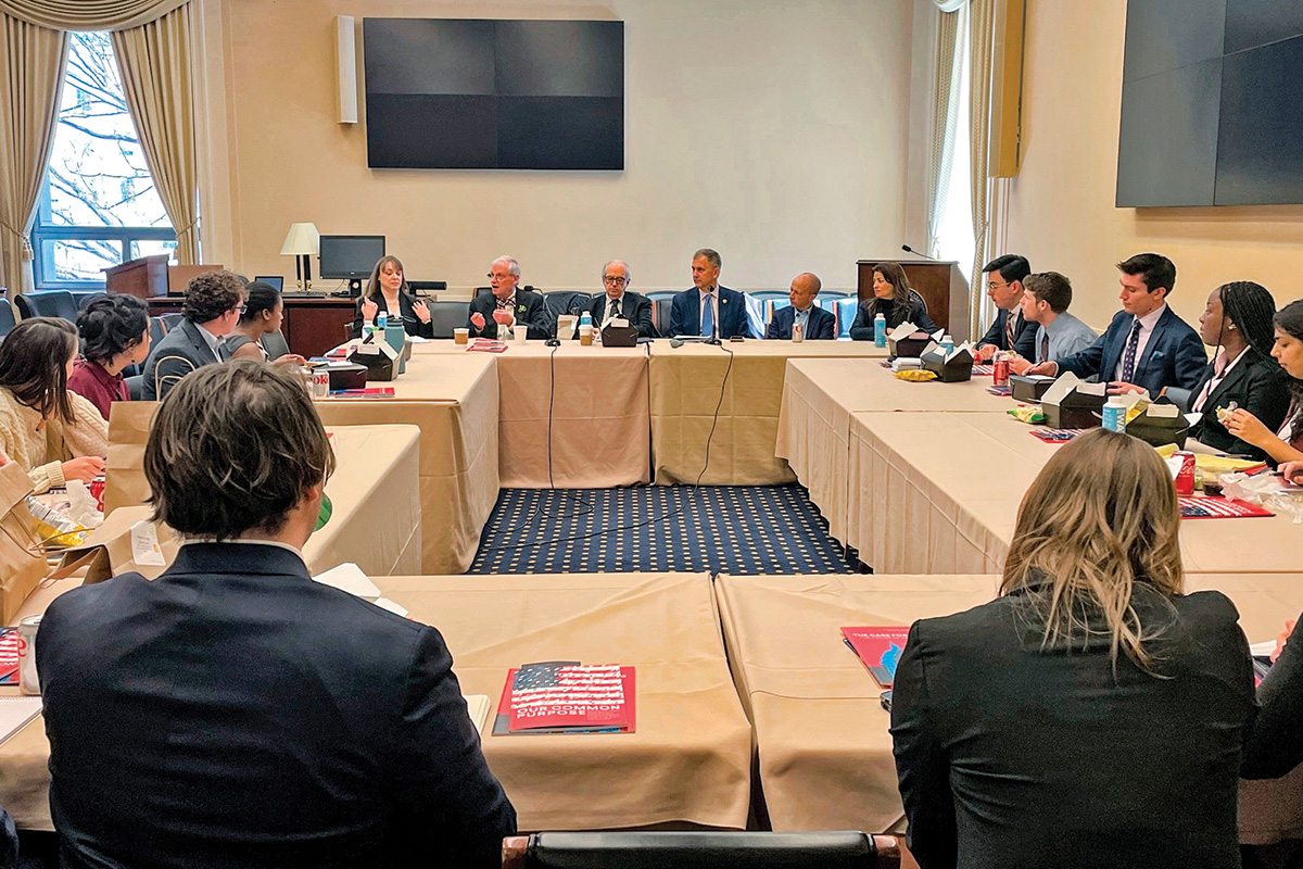 Two dozen people sit around a table, including Academy staff and congressional staff, to discuss policy reform.