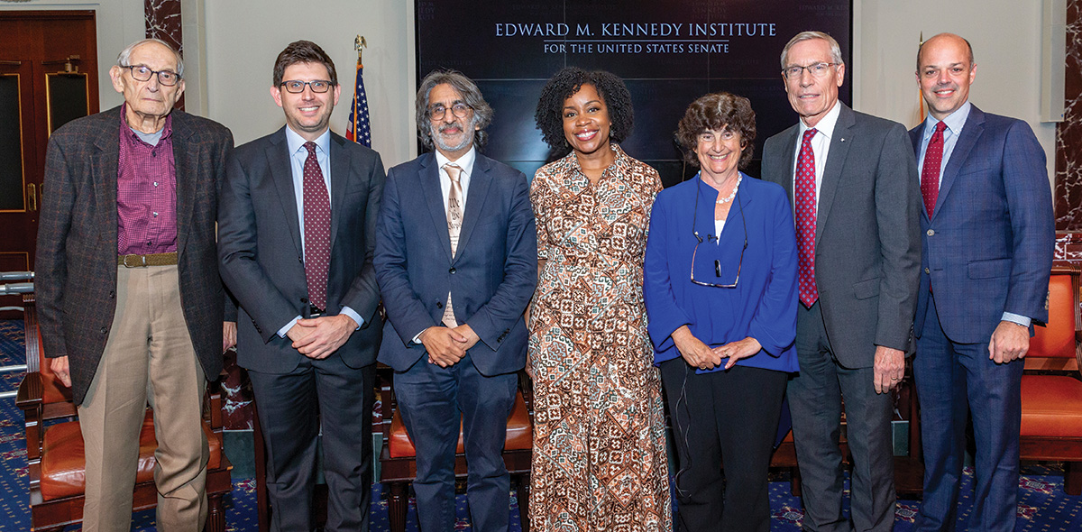 Four attendees stand beside the speakers from the event at the Edward M. Kennedy Institute for the United States Senate held to promote the Case for Supreme Court Term Limits report.