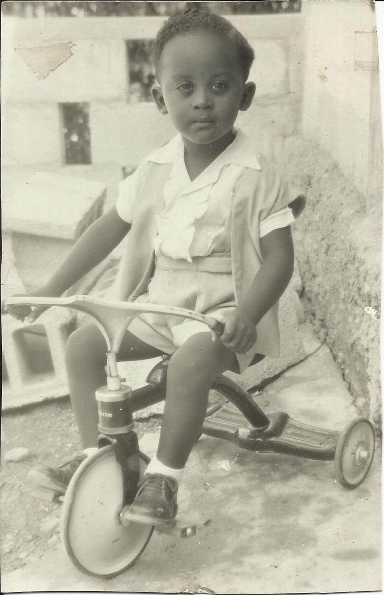 Michel-Rolph Trouillot on his tricycle as a young child. 