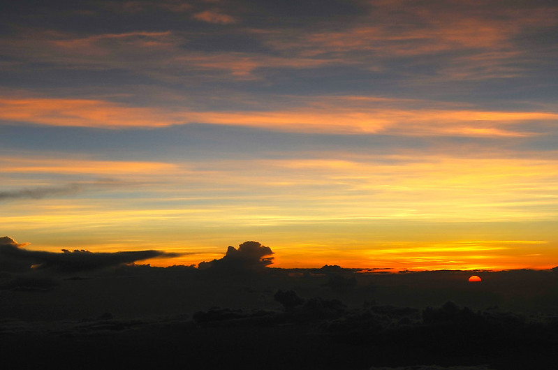 The Sun Descends into the Landscape with Orange Yellow and Bluegray Sky