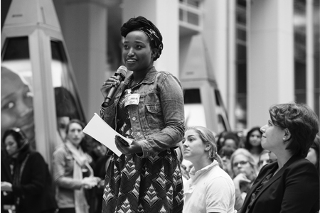 Audience member asks a question on the International Day of the Girl.