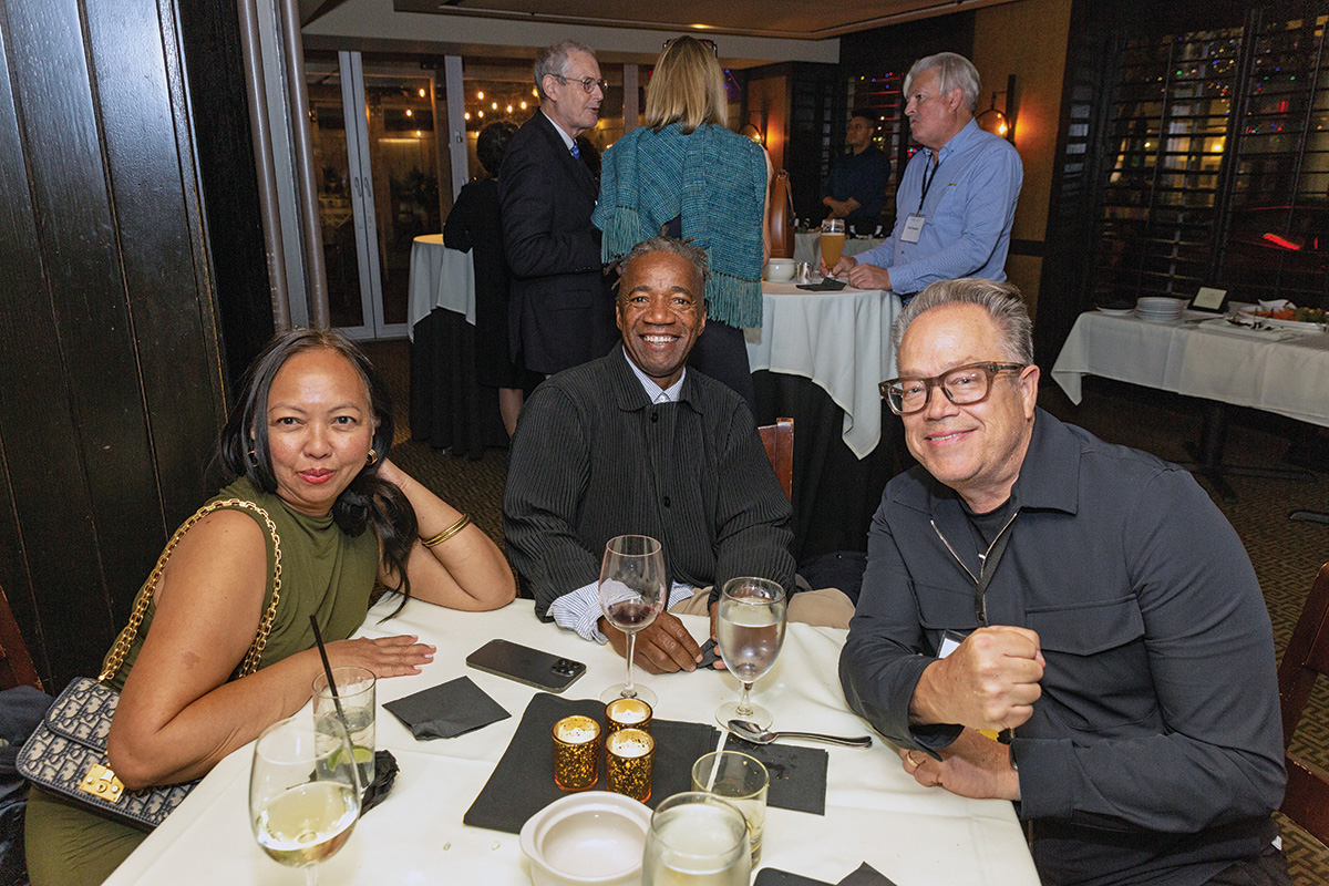 Three attendees gather at the receptions after the 2023 Induction ceremony.