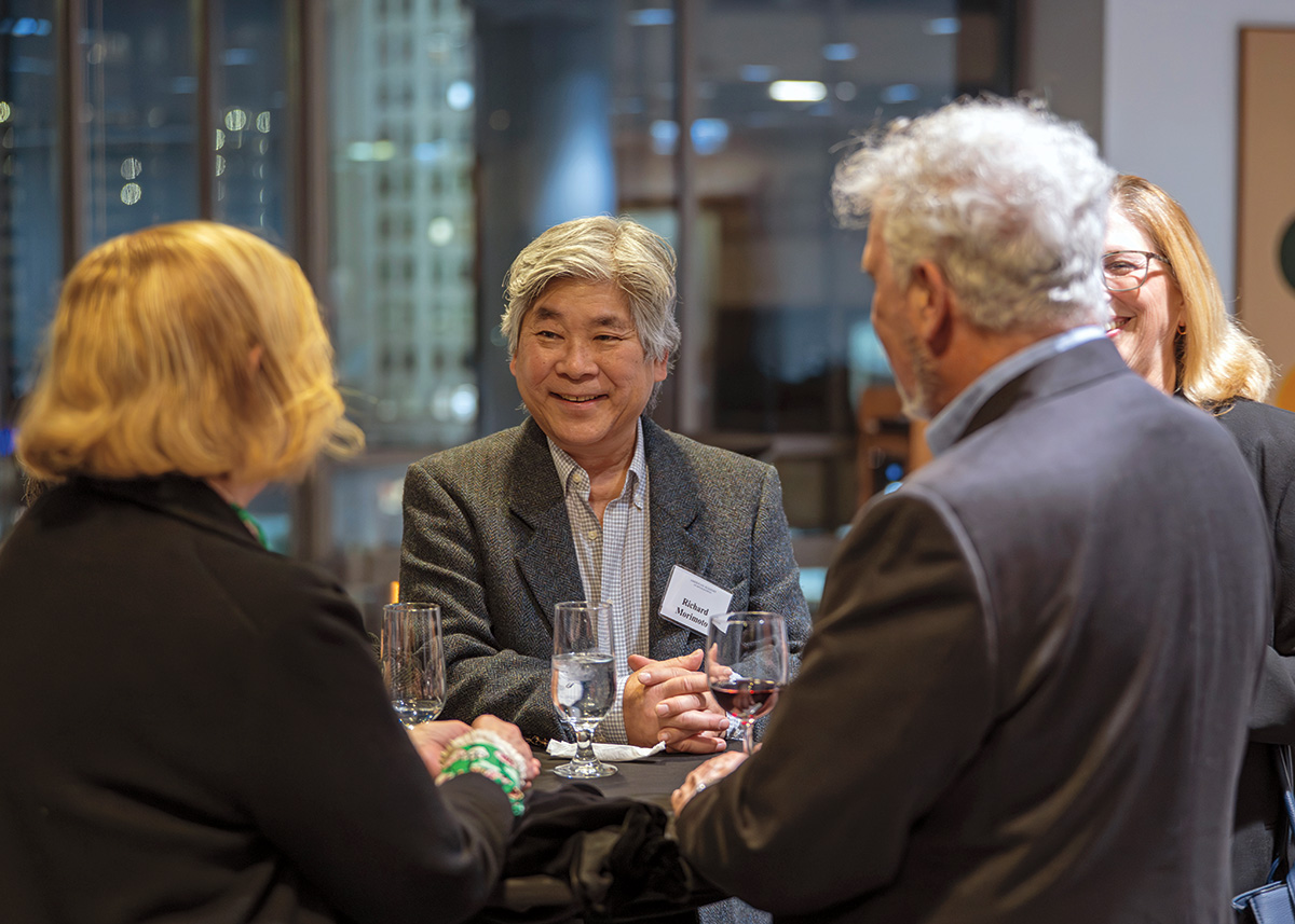 A man smiles during a reception. 