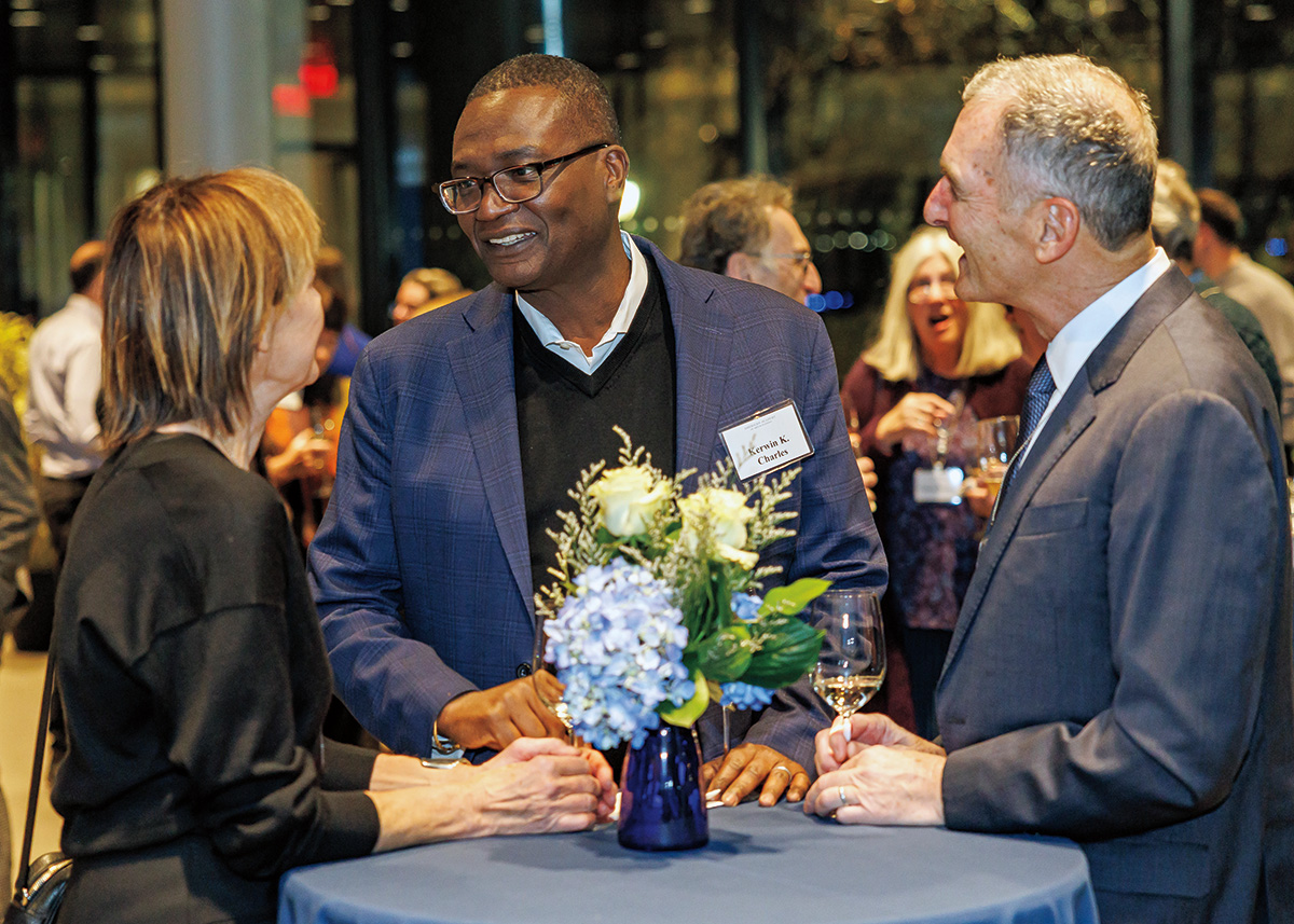 Formally dressed adults enjoy a nighttime reception. 