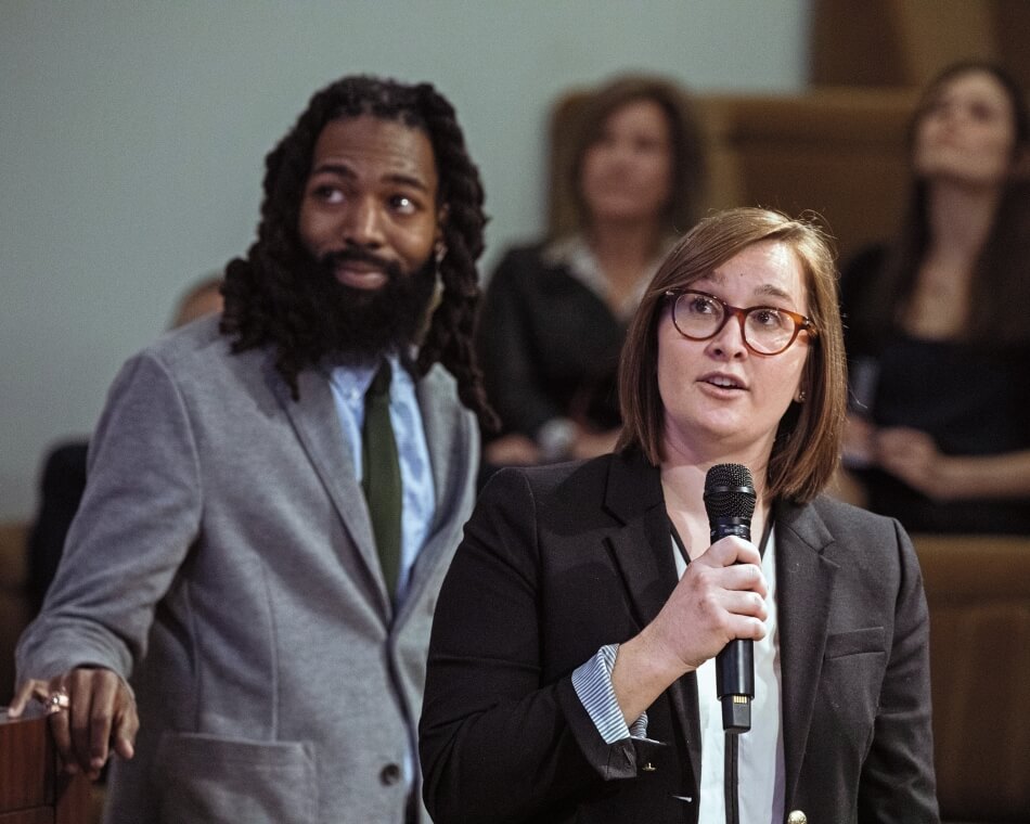Martha Stewart Photography Woman speaking into a microphone with African American male standing next to her. Photo by Martha Stewart Photography.