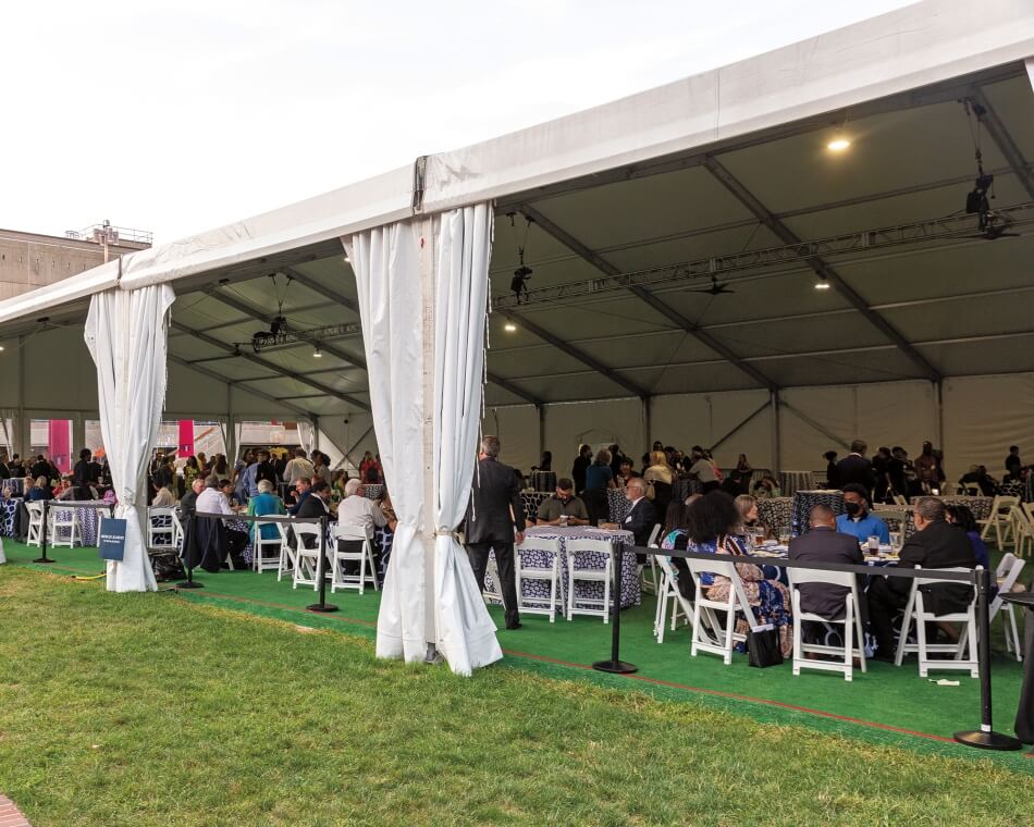 People in tent reception after the Induction Ceremony. 