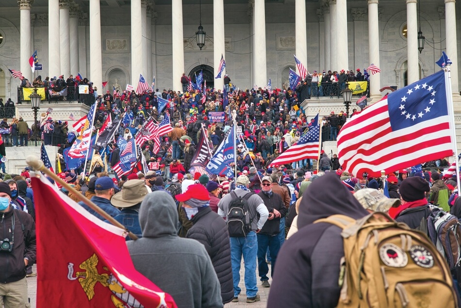 Hundreds of right-wing extremists holding American flags and flags in support of Donald Trump crowd the stairs of the Capitol Building in Washington, D.C. Photo by Brett Davis. Published under a Creative Commons Attribution-NonCommercial 2.0 Generic (CC BY-NC 2.0) license.