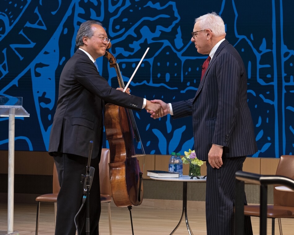 Yo-Yo Ma and David M. Rubenstein shaking hands. 