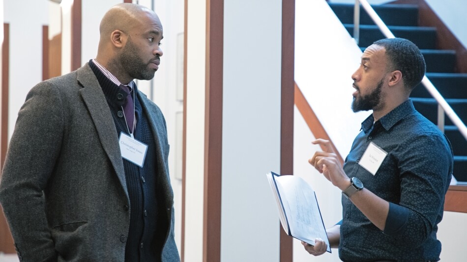 Christopher Jones (left), who participated in a listening session with faith leaders in New York City, and Jai Winston (right), who participated in a listening session with community leaders in St. Paul, MN, converse at the House of the Academy.  