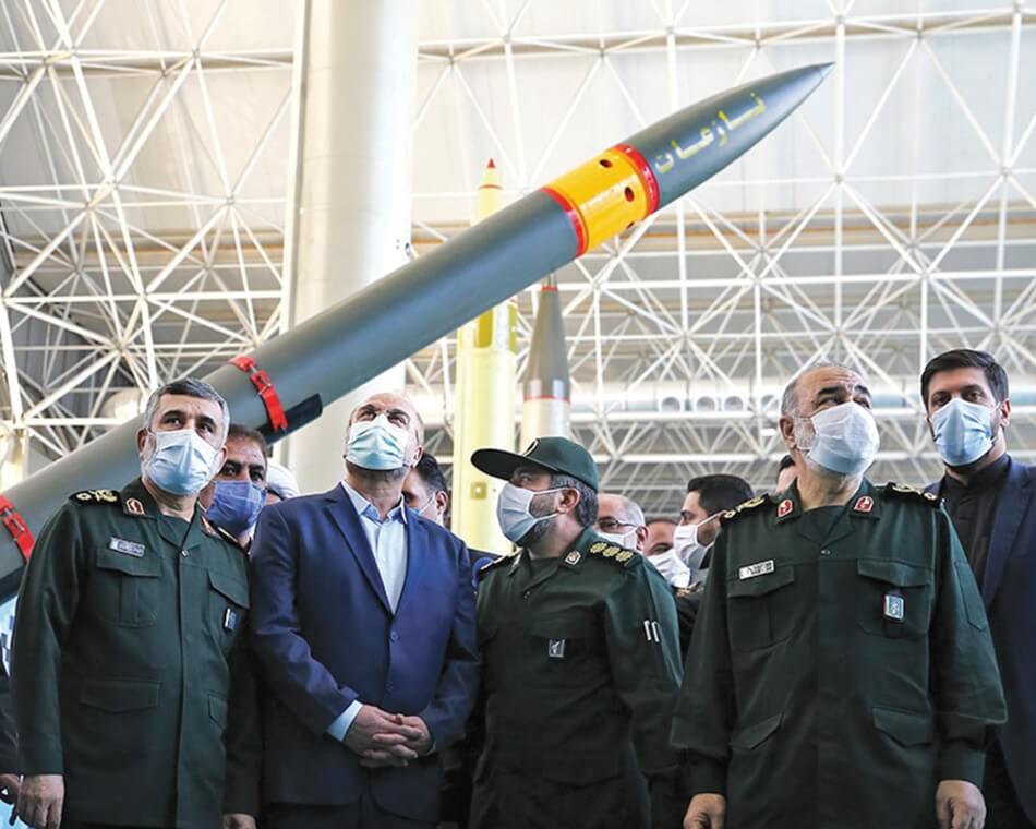 Men with masks on standing in front of a missile. Fars Media Corporation, M. Sadegh Nikgostar, licensed under the Creative Commons Attribution 4.0 International license