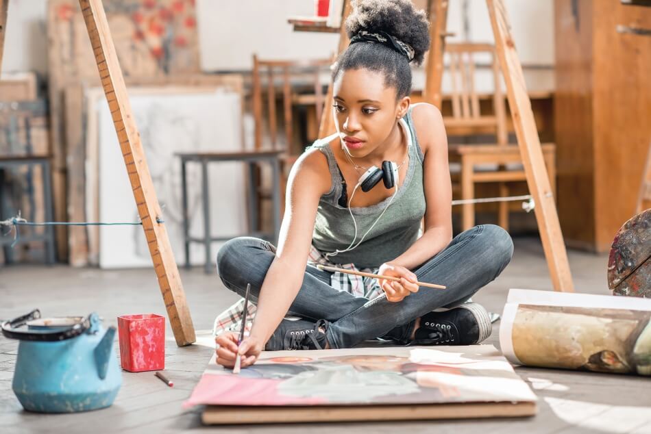 iStock.com/RossHelen Woman Painting