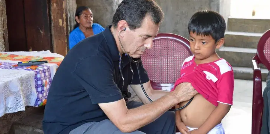 Paul Wise treating a child in a rural village in Guatemala