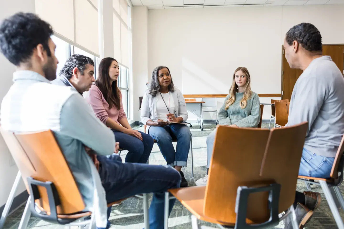 Small group discussion with people seated in chairs. 