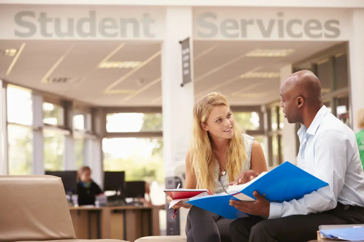College Student Having Meeting With Tutor To Discuss Work outside of Student Services