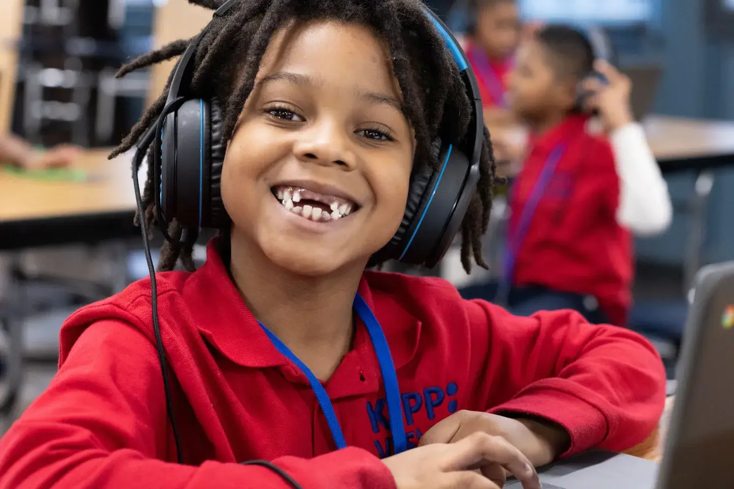 A smiling young male student working on his computer 