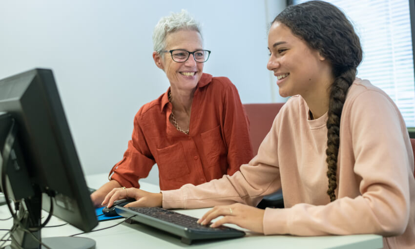 High school student receiving help from tutor after school 