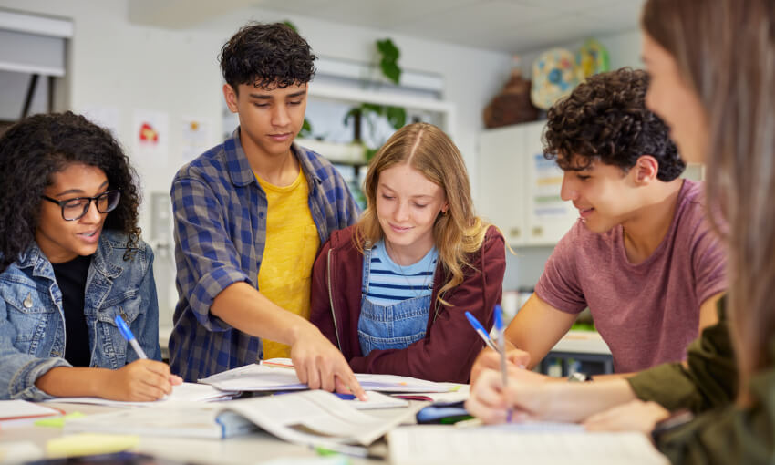 Multiethnic students studying together at secondary school