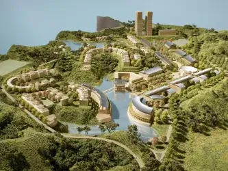 A digital rendering shows an aerial view of a model of the initial campus plans designed by Moshe Safdie for the Asian University for Women. The model has curving green spaces, roads, small bodies of water, and beige buildings.