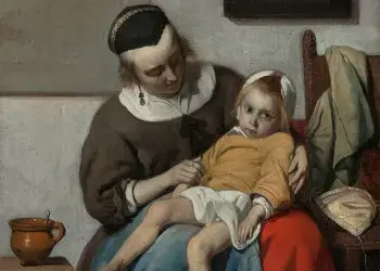 A portrait of an ill child sitting on a caregiver’s lap, slouching to the point of practically lying down. The caregiver looks to the child. The child looks toward the viewer.