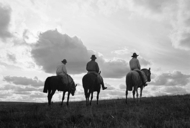 Three cowboys ride the range, c. 1930–1940