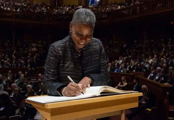 Ursula Burns signing the Book of Members