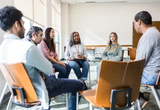 Small group discussion with people seated in chairs. 