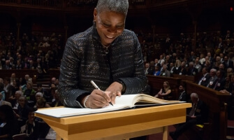 Ursula Burns signing the Book of Members