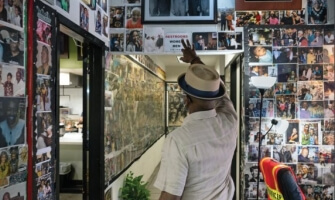 Black Man in His Home surrounded by Images of Family and History