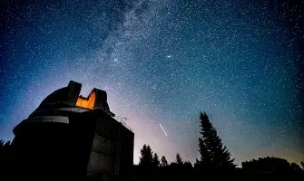Night sky with stars and observatory.
