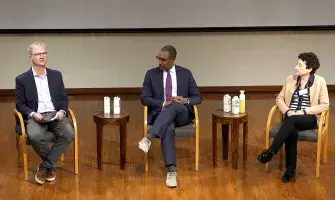 Three speakers in discussion about rebuilding trust in science.
