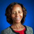 A photo of Marian Croak, a person with dark skin and dark hair, wearing business attire and smiling at the viewer.