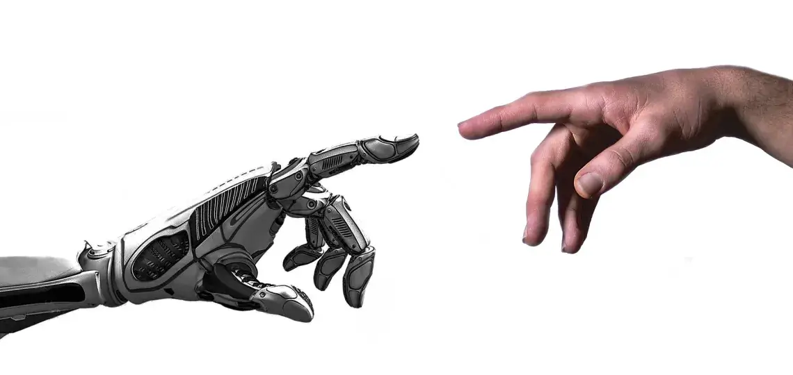 A metallic robotic hand and a human hand nearly touching. 