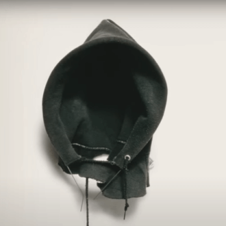 Black hood from a hoodie, which is from the cover of the book Citizen by Claudia Rankine. 