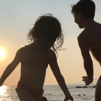 Children at the beach at sunset