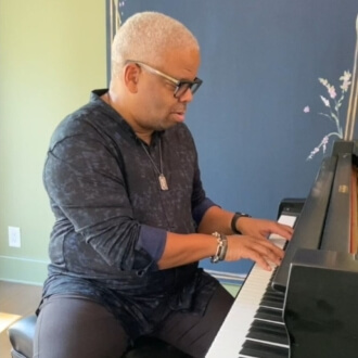 Terence Blanchard playing piano in his home