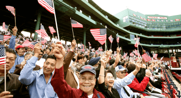Immigrants cheer during naturalization ceremony at Fenway Park