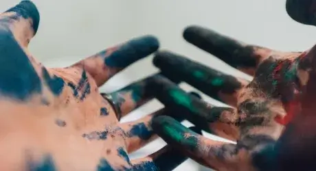 Hands covered in paint. 