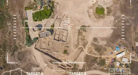 A view from a drone of land below with target and weapon outlines. 