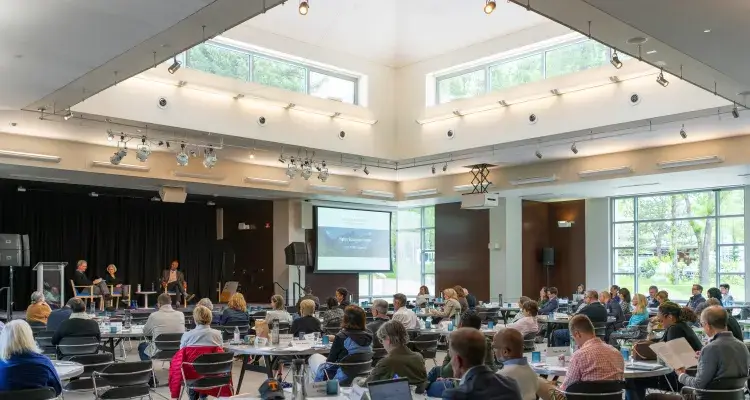 A full room of conference attendees 