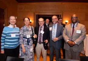 Five attendees from New York members reception standing in Red Room of Century Association