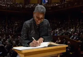 Ursula Burns signing the Book of Members